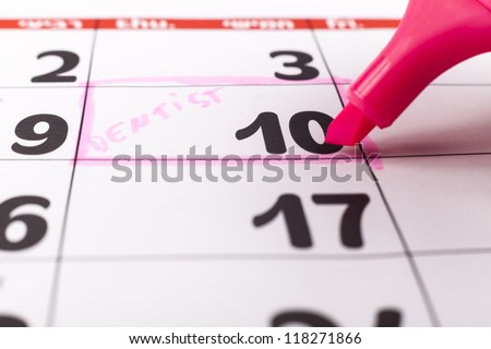 Calendar with dentist appointment on the 10-th highlighted with pink marker