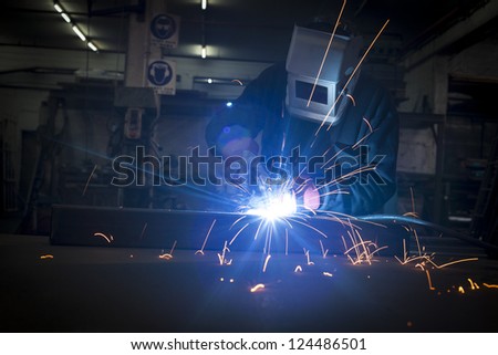 Welder working in a steel construction factory