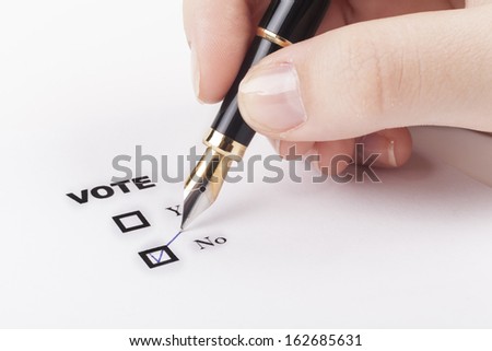 Woman hand voting no in check-box with blue fountain pen