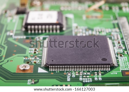 Microchip close-up on green electronic circuit board