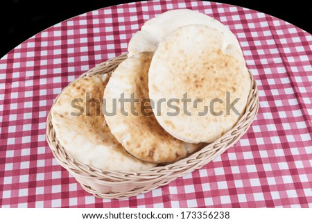 israeli flat bread on table and black background