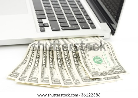 one dollar bills pouring out of a laptop side slot