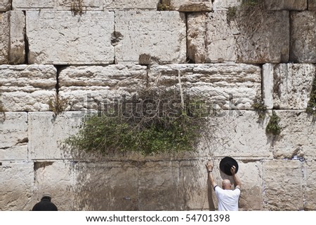 two man pray at the western wall in jerusalem