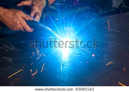 welding close-up bright light and two hands working