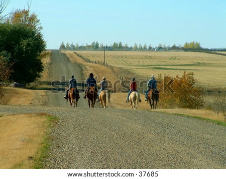 A group of ranch folks on their way to get the cows.