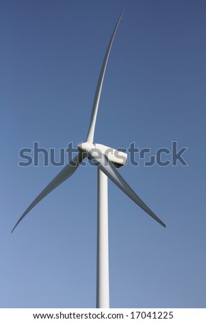 Electricity generating windmill against a clear blue sky