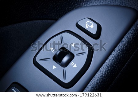 Car, vehical interior with visible electric exterior mirrors switches and interior global locking switch in contemporary, modern vehicles.
