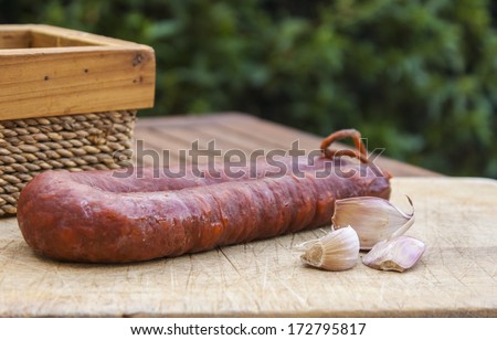 Spanish sausage on wooden board on the table in the terrace