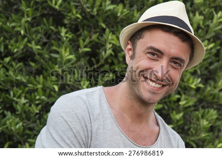 Man between 35 and 40 years casual dress with hat looking funny at the camera Man between 35 and 40 years casual dress with hat looking funny at the camera