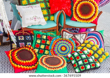 Beautiful and colorful handmade cushions, displayed in a hippy market of Ibiza, Balearic Islands, Spain