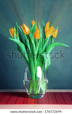 vase with tulips on the desk