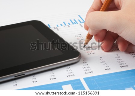 Concept of business report analysis - hand with pencil, digital tablet, graph and sheet. You may place your own screen, for example web page on tablet screen.