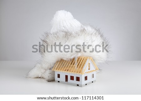 Cap isolate model of rough construction house against heat leak - unfinished house insulation concept. Prepare rough construction for winter concept.