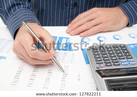 Business analysis - calculator, sheet, graph, (business report) and analyst.