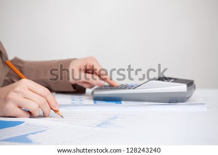 Business analysis - calculator, sheet, graph, (business report) and analyst woman. Selective focused on pencil.
