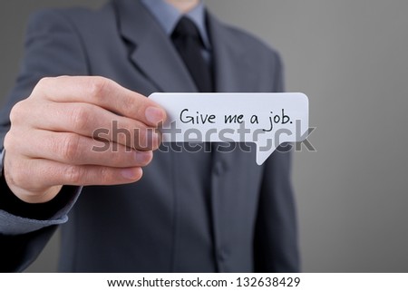 Young businessman hold comics bubble with text Give me a job. Unemployed person (jobless, out of work) concept.