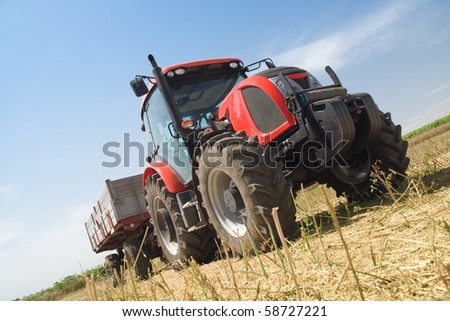 Agriculture - tractor on the field with harvested corn - dynamic composition