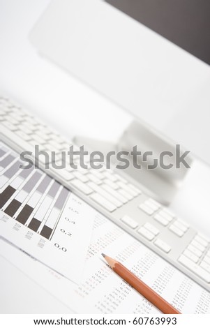 Concept of market share analysis - pencil; graph; sheet with numbers, keyboard and computer