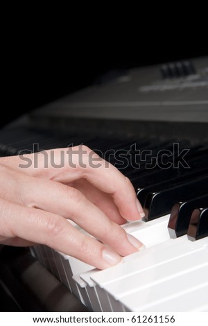 Musician play piano synthesizer - piano key and woman hand closeup