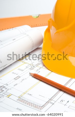 Blueprints of architecture interior, pencil, protective helmet and bubble level