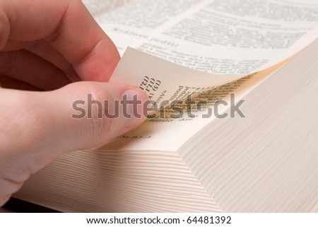 Male hand browse through the open book