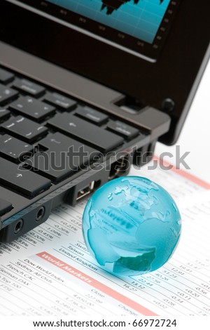 World markets analyze concept - laptop, glass globe and printed data sheet