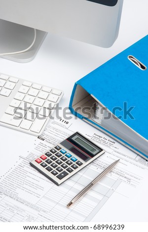 Tax concept - tax form, part of computer, keyboard, calculator, office folder and pen