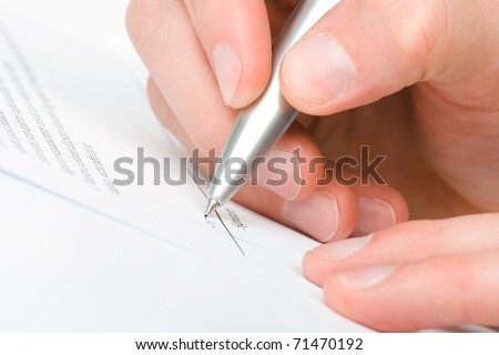 Signing a contract - hand with pen closeup