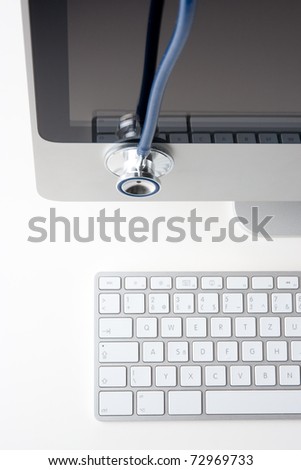 Doctor out of office - stethoscope situated on computer LCD
