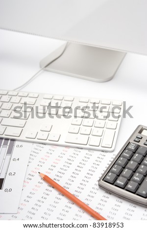 Concept of business analyst workplace - pencil, sheet with numbers, graph, keyboard, computer and calculator