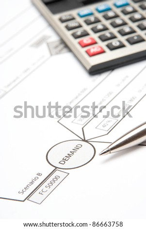 Decision tree close-up with calculator and pen - instrument for management