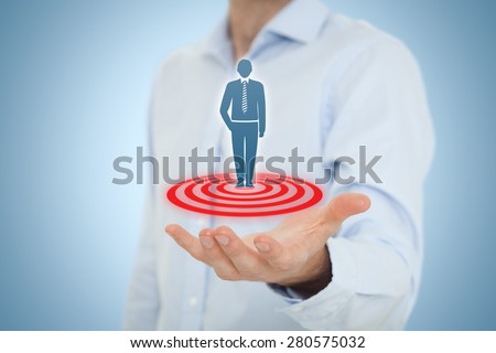Target customer (marketing) concept. Businessman hold target customer represented by virtual icon of man standing on target. Central composition.