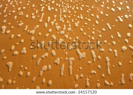 Beach sand whit rising tide, abstract background
