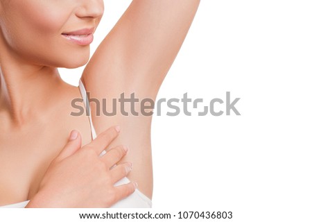 Armpit epilation, lacer hair removal. Beauty Young Woman holding her arms up and showing clean underarms, depilation smooth clear skin. Beauty portrait. Beautiful Girl after removal hair under her arm