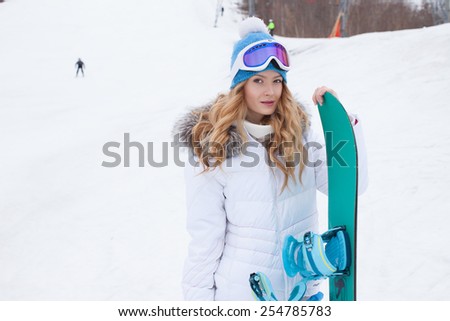 women winter . beautiful girl with a snowboard in the hands of