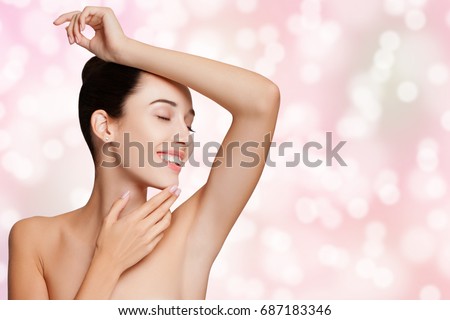 Beautiful young Woman holding her Arms up and Showing Clean Underarms. Armpit\'s Care. Armpit Epilation, Hair Removal, Perfect Skin