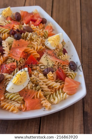Pasta salad with olives, tomato, beetroot, cucumber, smoked salmon and boiled egg