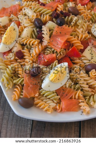 Pasta salad with olives, tomato, beetroot, cucumber, smoked salmon and boiled egg