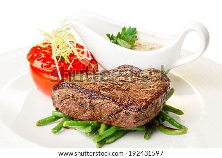Grilled beef steak with vegetable garnish. Hearty steak dinner.