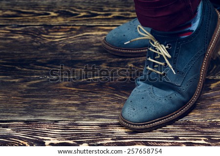 Close up of men\'s brogues (also known as derbies,gibsons or wingtips) made from blue oiled suede