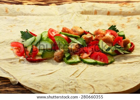 Traditional shawarma with chicken and vegetables in unwrapped condition