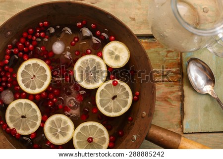 Cranberry lemon punch in a brass bowl on wooden table