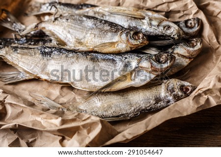 Dried fish on wooden table. Selective focus, narrow depth of field.