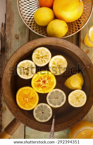 Top view of brass pot with lemonade,detox water or punch with lemons and oranges