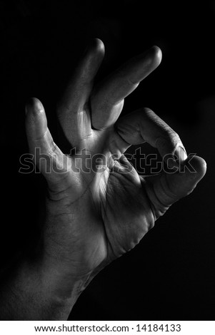 Black and white men\'s hand demonstrates Ok gesture