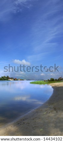 Vertical panorama of lake with beautiful blue sky