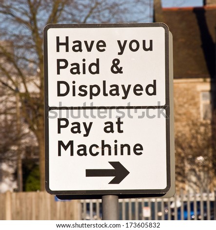 Road sign in the UK informing motorists where to pay in order to park their cars legally.