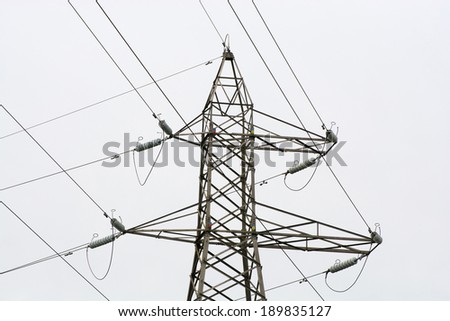 Grey electricity pylon against a grey sky