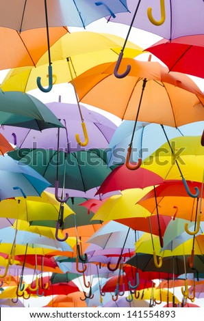 A lot of open multicolored umbrellas. Color background
