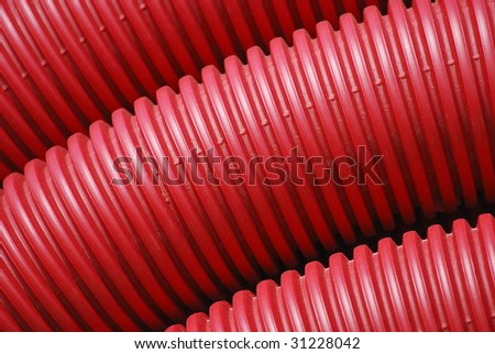 Red plastic tubes stacked. Construction concept